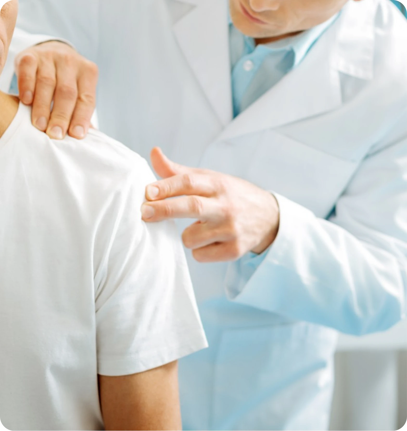 Clinician examining a patient’s shoulder