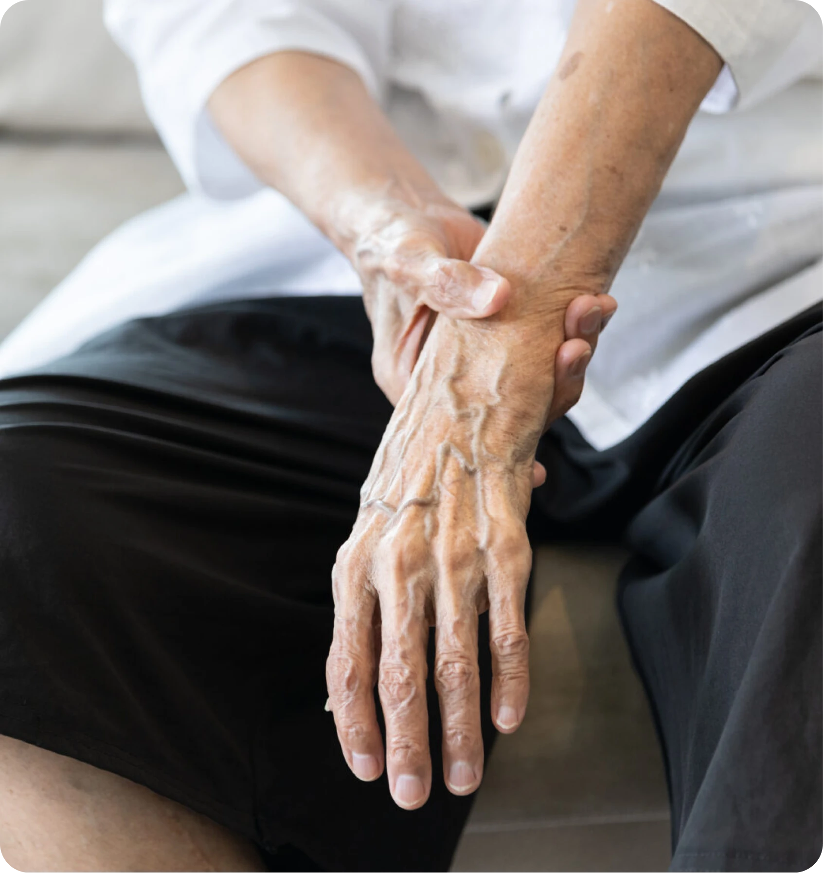 Older adult holding their wrist in discomfort