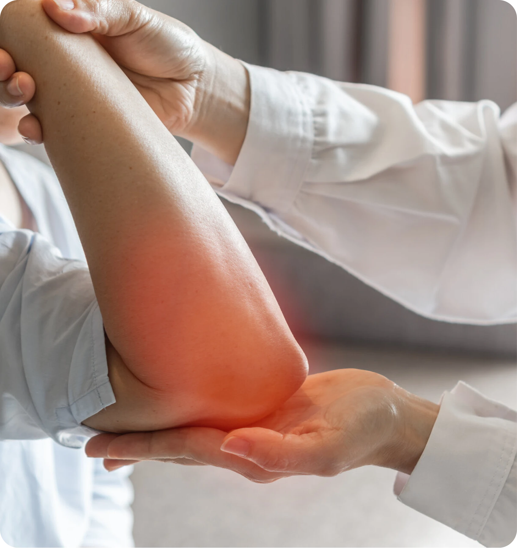 Clinician examining a patient’s elbow with a red pain highlight