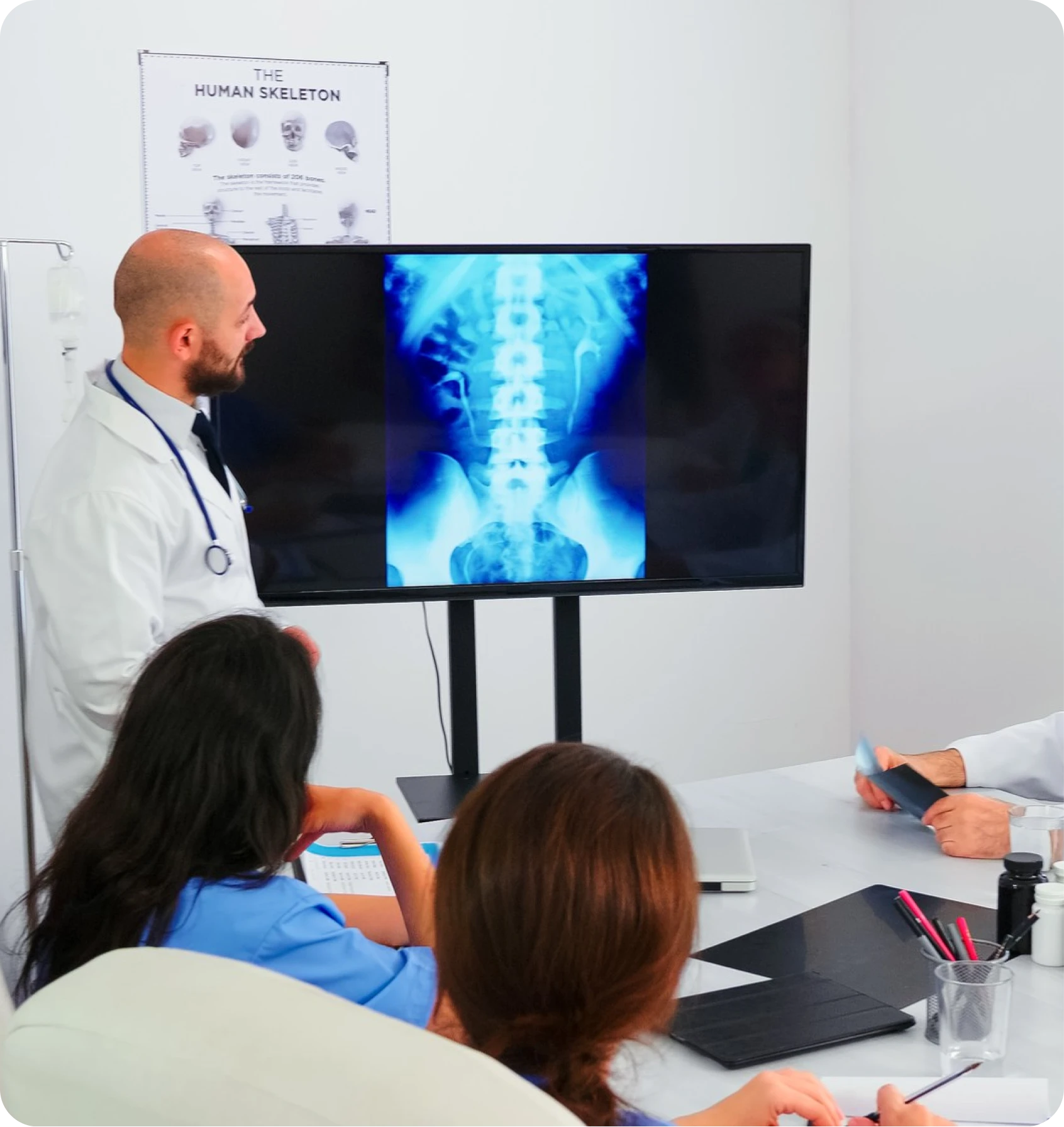 Physician presenting a spinal X-ray on a monitor